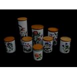 Eight Portmeirion pottery storage jars decorated in the Botanic Garden pattern, with wooden lids, so