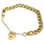 A 9ct gold charm bracelet, the heavy curb link bracelet with a heart shaped padlock and safety chain