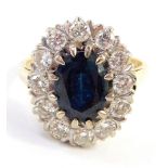 A sapphire and diamond set dress ring, the central oval sapphire in a claw setting, 9.2mm x 6.6mm x