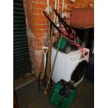 A Qualcast electric mower and a quantity of garden tools.