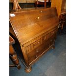 A 1950s oak bureau.