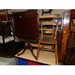 A late 20thC mahogany tilt top table, with fret work galleried top raised on acanthus carved legs, (