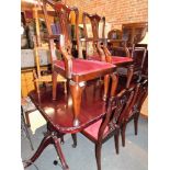 A reproduction mahogany Chippendale design extending dining table, and six chairs including two carv