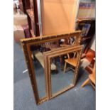 A decorative mirror in gilt coloured frame with bevelled glass, another smaller, frame, and a CD rac