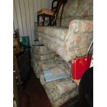 A four piece suite, comprising three seater settee, two armchairs and a foot stool, upholstered in a