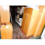 A mid 20thC light oak four piece suite, comprising two wardrobes, dressing table and single bed fram