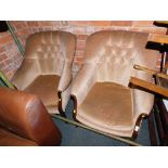 A pair of upholstered button back tub armchairs.