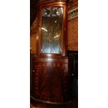 A mahogany reproduction corner display cabinet.