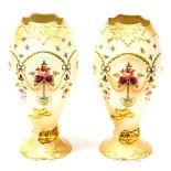 A pair of Crown Devon blush ivory vases, each with goblet type waved stem, with floral detailing, pi