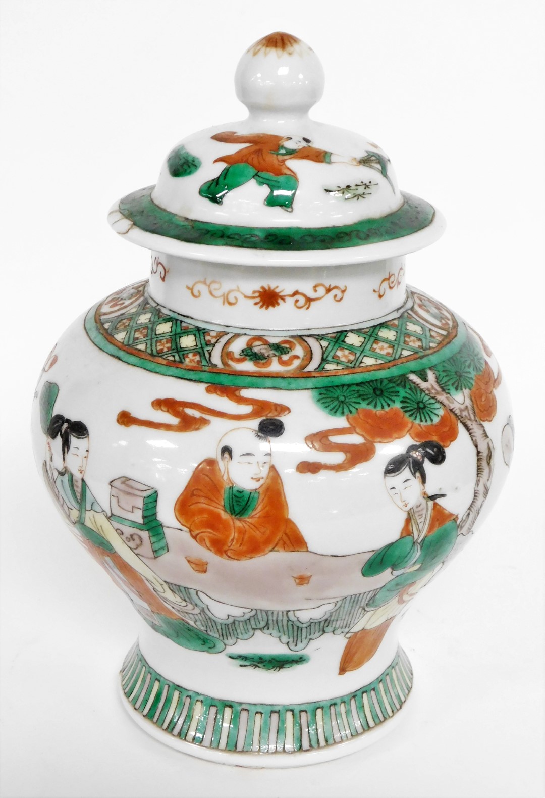 A Chinese ginger jar and cover, heavily decorated with green and red borders, and figures under tree