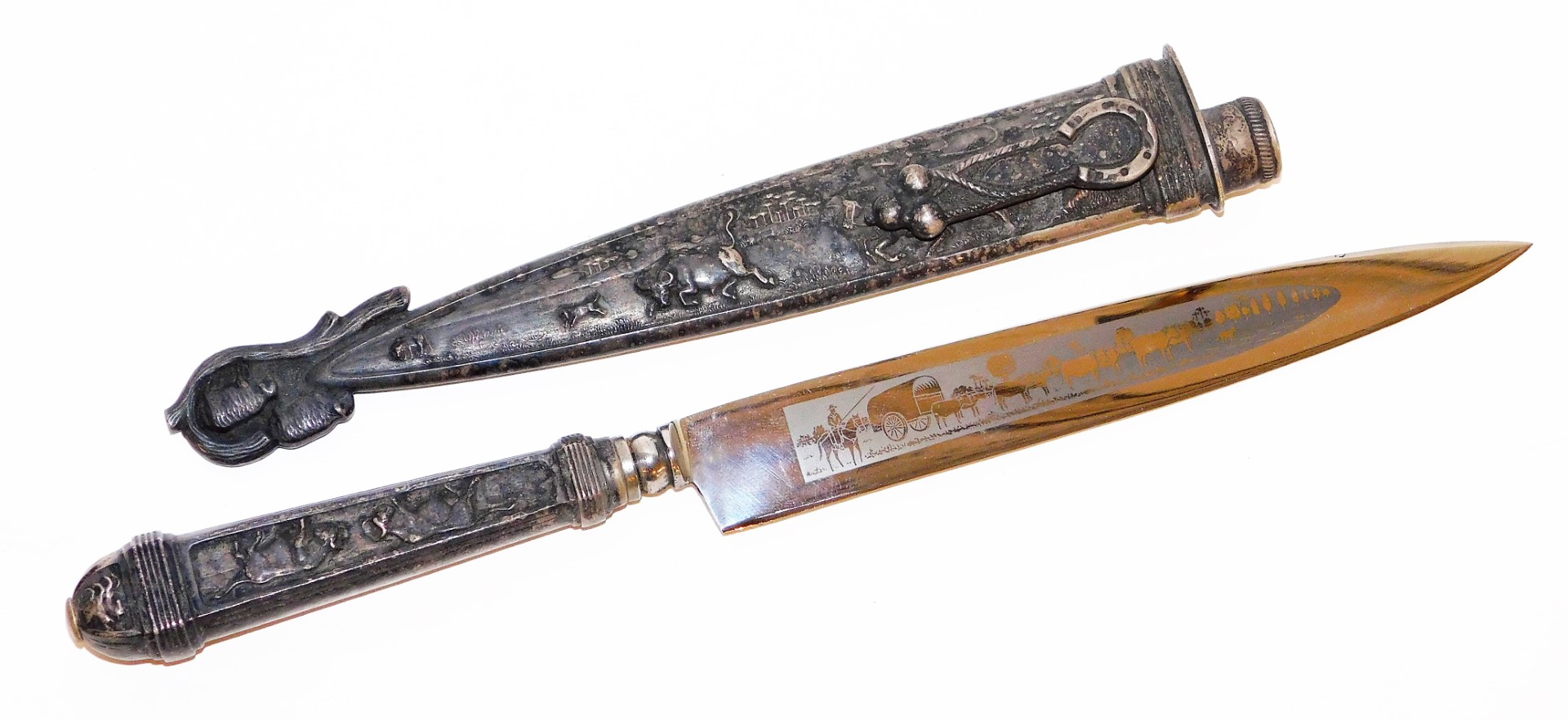 An Inox hunting knife, in a silver plated scabbard, heavily embossed with cattle scenes, of cows, bu - Image 2 of 2