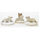 Three Staffordshire sheep ornaments, 7cm high, 27cm high, 18cm high. (3)