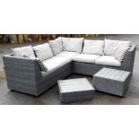 A rattan garden corner suite, with coffee table insert and three seat sections, with cream cushions.