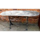 A marble topped and cast iron base table, the top with rounded corners, on X frame metal base, 73cm