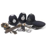 Police memorabilia, three various Metropolitan police helmets, two wooden truncheons, badges, belts,