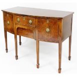 A George III style bowfront mahogany sideboard, with curved top above two cupboard doors and a singl