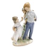 A Lladro figure group, of friends and family, with a boy having a piggyback, and girl with reading b