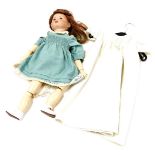 A bisque headed Jumeau doll, stamped S F B J Paris 252, with long brown hair and plaster body, with