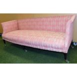 A Victorian upholstered three seater sofa, with a pink ribbon and urn design, on ebonised mahogany l