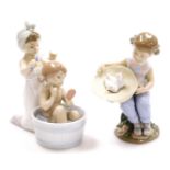 Two Lladro figure groups, to include a girl having a bath, with figure brushing hair no. 6457, 17cm