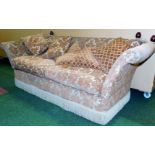 A Knole style three seater sofa, upholstered in a gold and orange floral upholstery, 85cm high, 240c