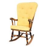 An Ercol style rocking chair, with yellow upholstered cushions, light elm, 102cm high, 53cm wide, 55