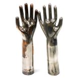 A set of silvered metal hand displays, possibly glove formers, 37cm high.