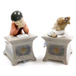 Two Nao porcelain figures, of children at desk, reading and writing, boy and girl, no.1403 and 1494,