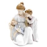 A Lladro figure group, of mother holding baby with child, no. 6939, 23cm high.