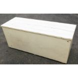 A white painted pine tool chest, with four panelled top, 54cm high, 127cm wide, 44cm deep.