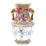 A Chinese vase, with pink yellow and green panel decoration, and gilt handles with octagonal panelle