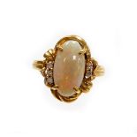 An opal and diamond dress ring, the oval opal in four claw setting with rococo scroll bordering and