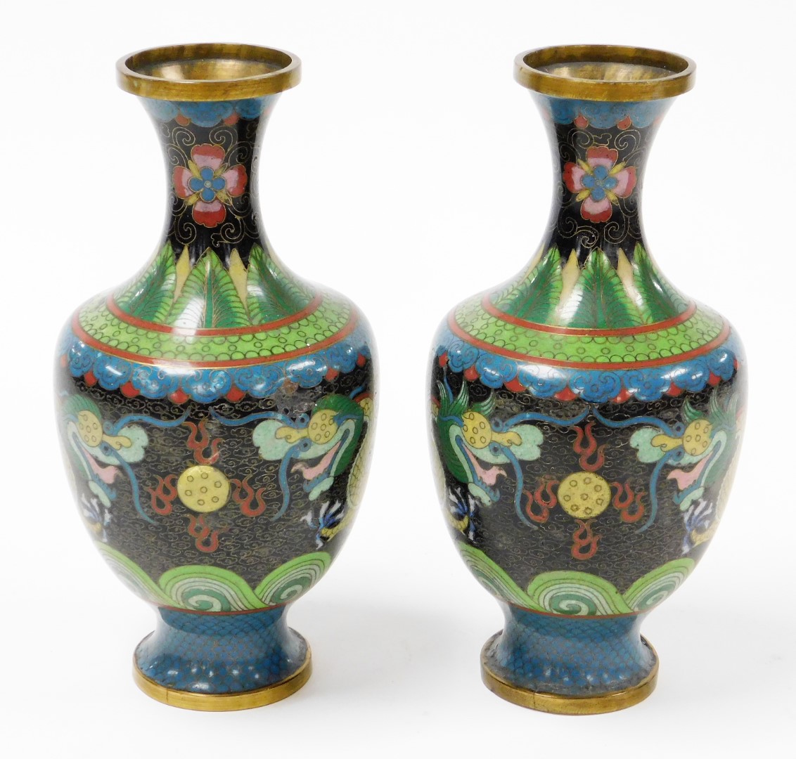 A pair of cloisonné vases, each decorated on a blue and black ground with dragons, 23cm high. (AF)