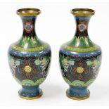 A pair of cloisonné vases, each decorated on a blue and black ground with dragons, 23cm high. (AF)