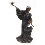 A contemporary bronze figured candlestick, of a standing female, in a long flowing dress and holding