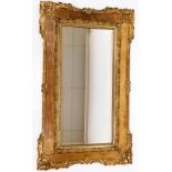 An Edwardian gilt framed wall mirror, with central rectangular mirror plate, and carved floral borde