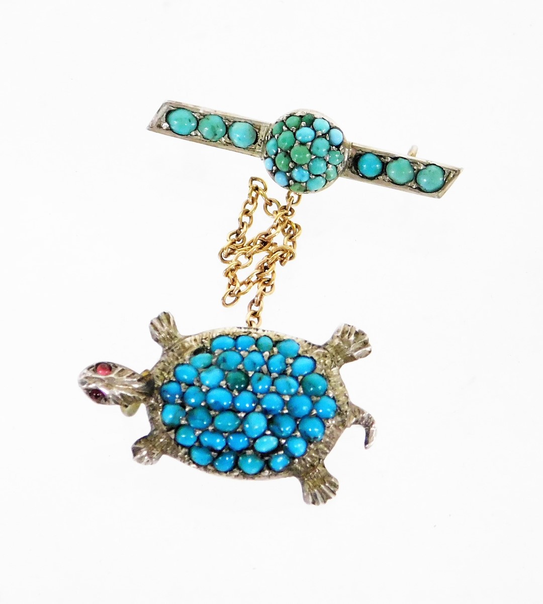 A turquoise and garnet set turtle brooch, with later bar pin and safety chain, in white metal stampe