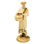 A Royal Worcester blush ivory figure of a gentleman carrying water jug, numbered 125, 23cm high.