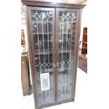 An oak finished glazed bookcase, with cornice top above two glass doors, 187cm high, 93cm wide, 36cm