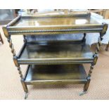 A mahogany three tier hostess trolley, with partial barley twist columns and reeded tray supports,