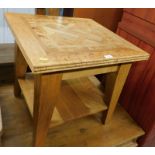 A marquetry inlaid coffee table, of two tiers on tapered legs, 56cm high, the top 60cm x 60cm.