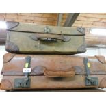 Two suitcases, comprising a green canvas bound case and a leather bound case. (2)