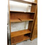 A retro teak bookcase, with three book shelf top but one can be converted to a cupboard with