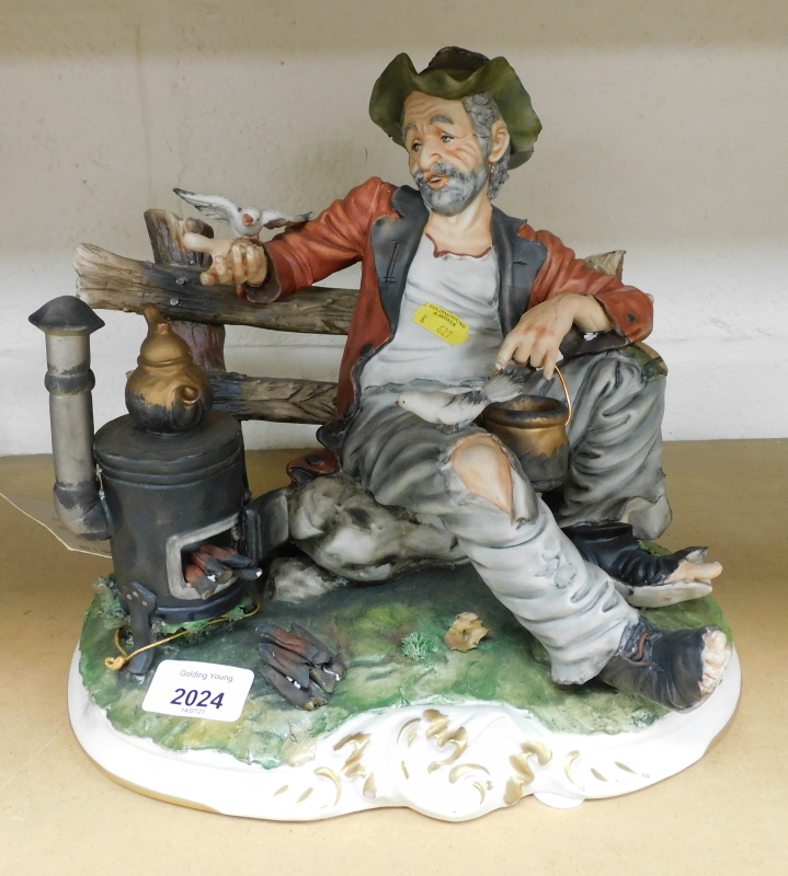 A Capodimonte Lory figure group of a seated gentleman with log burner, 29cm high, with Capodimonte