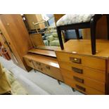 A vintage teak bedroom suite, comprising two door wardrobe, dressing table, and four drawer chest.