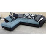 A black and charcoal corner sofa, on black base with charcoal cushions and arrowed back supports, on