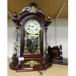 A Highlands mahogany cased mantel clock, with applied gilt figures of cherubs and masks, with