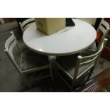 A white painted finished circular dining table and four matching chairs.