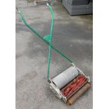 A vintage push along mower, by Ransoms.