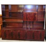 A mahogany finish wall unit, with sectional top above cupboard base, 166cm high.